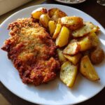 Golden chicken schnitzel with crispy fried potatoes