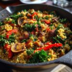 Quinoa veggie skillet with mushrooms, kale, red pepper and a light Mediterranean seasoning.