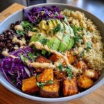 Roasted sweet potato & black bean Buddha bowl drizzled with tahini-lime dressing.