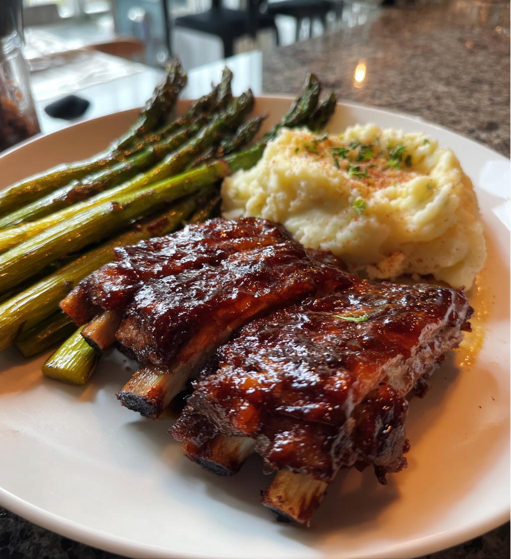 Tender Oven-Baked Ribs with mashed potatoes and roasted asparagus
